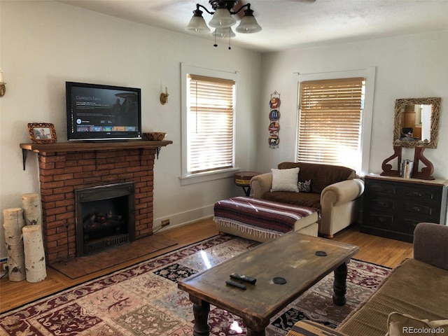 40 Bronk St, Monte Vista, CO 81144 - living room featuring a ceiling fan, wood finished floors, and a brick fireplace