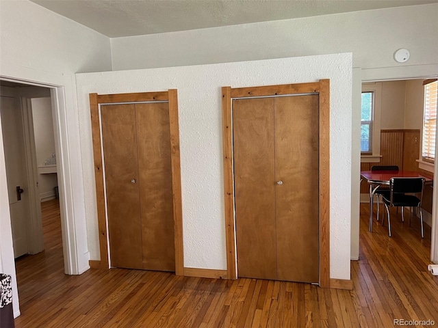 40 Bronk St, Monte Vista, CO 81144 - unfurnished bedroom featuring wood finished floors, two closets, and lofted ceiling