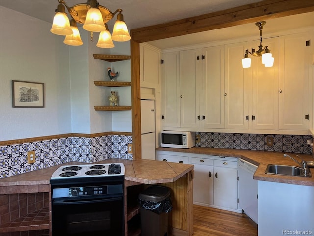 40 Bronk St, Monte Vista, CO 81144 - kitchen featuring black appliances, a chandelier, backsplash, white cabinets, and open shelves