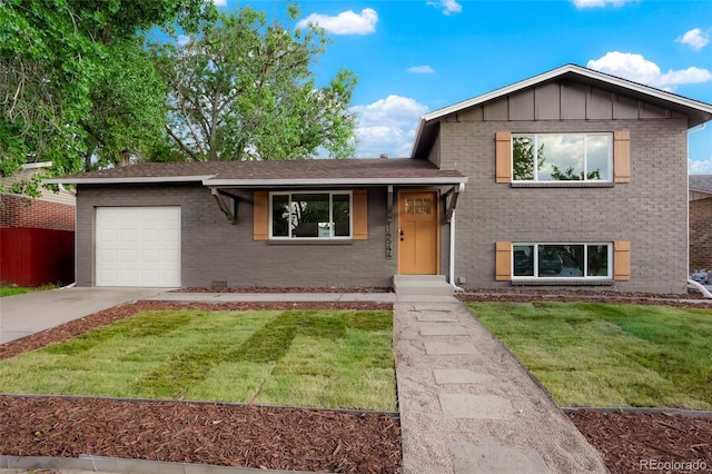 14544 March Dr, Denver, CO 80239 - split level home featuring an attached garage, brick siding, concrete driveway, a front lawn, and board and batten siding