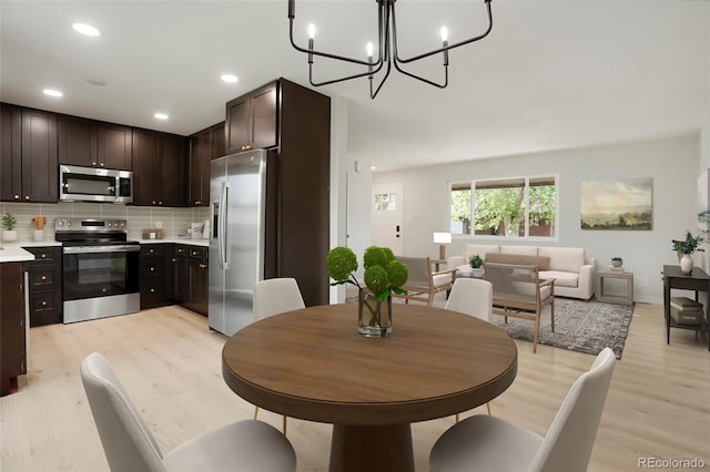 14544 March Dr, Denver, CO 80239 - dining area featuring light wood-type flooring, a chandelier, and recessed lighting