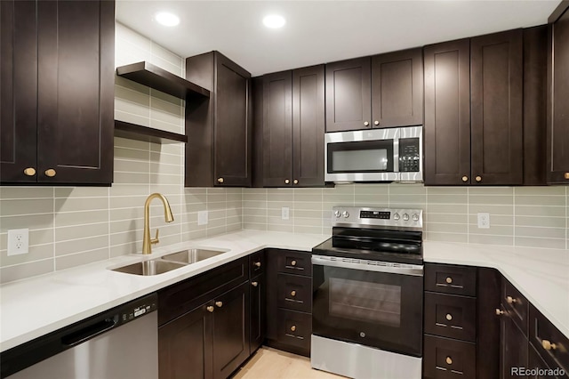 14544 March Dr, Denver, CO 80239 - kitchen featuring appliances with stainless steel finishes, backsplash, dark brown cabinets, and recessed lighting