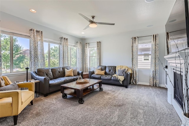 living room with ceiling fan, plenty of natural light, and carpet floors