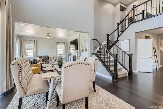 dining room featuring a high ceiling, dark hardwood / wood-style floors, and ceiling fan