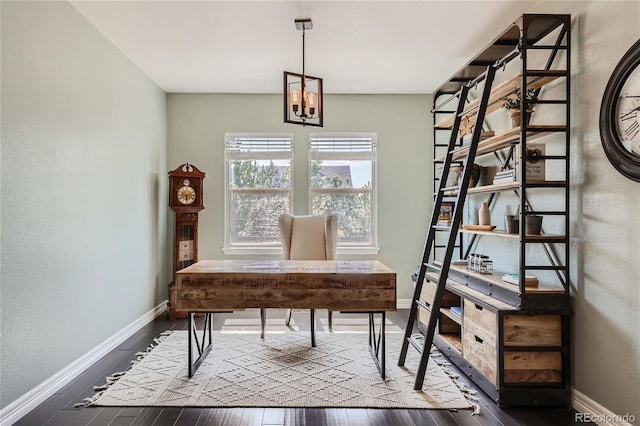 home office with an inviting chandelier and dark hardwood / wood-style flooring