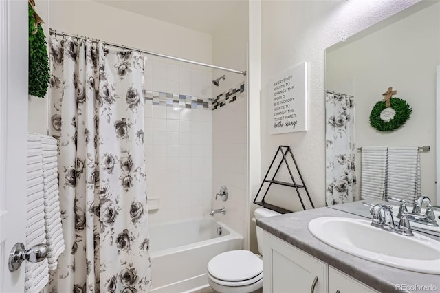 full bathroom featuring shower / bath combination with curtain, vanity, and toilet