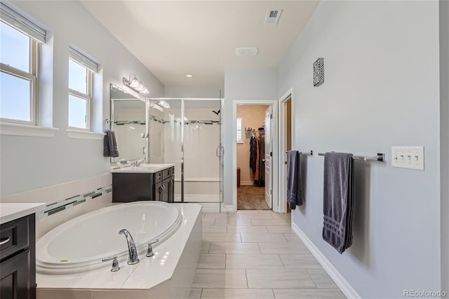 bathroom with vanity, independent shower and bath, and tile patterned flooring