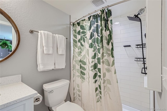 bathroom with vanity, a shower with curtain, and toilet