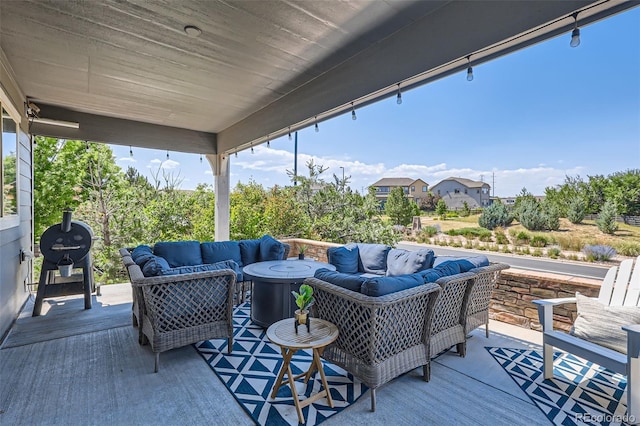 wooden deck with grilling area and an outdoor living space with a fire pit