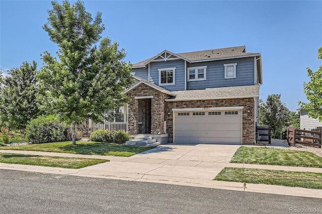 craftsman-style home with a garage and a front yard