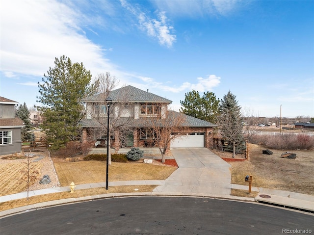 traditional-style house with a front lawn, brick siding, a garage, and driveway