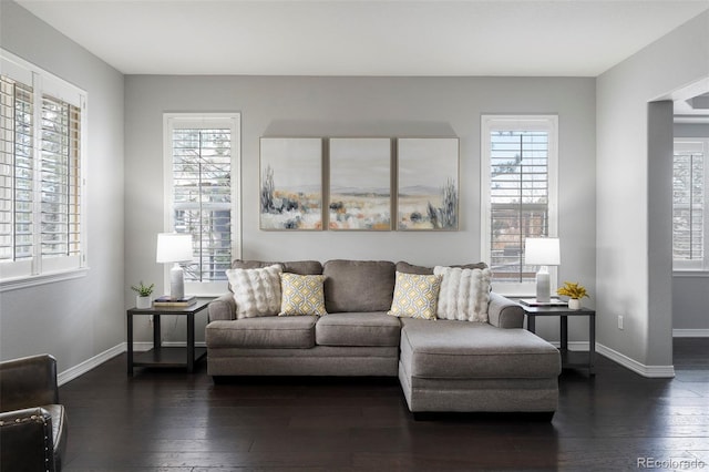 living room with dark wood-style floors and baseboards