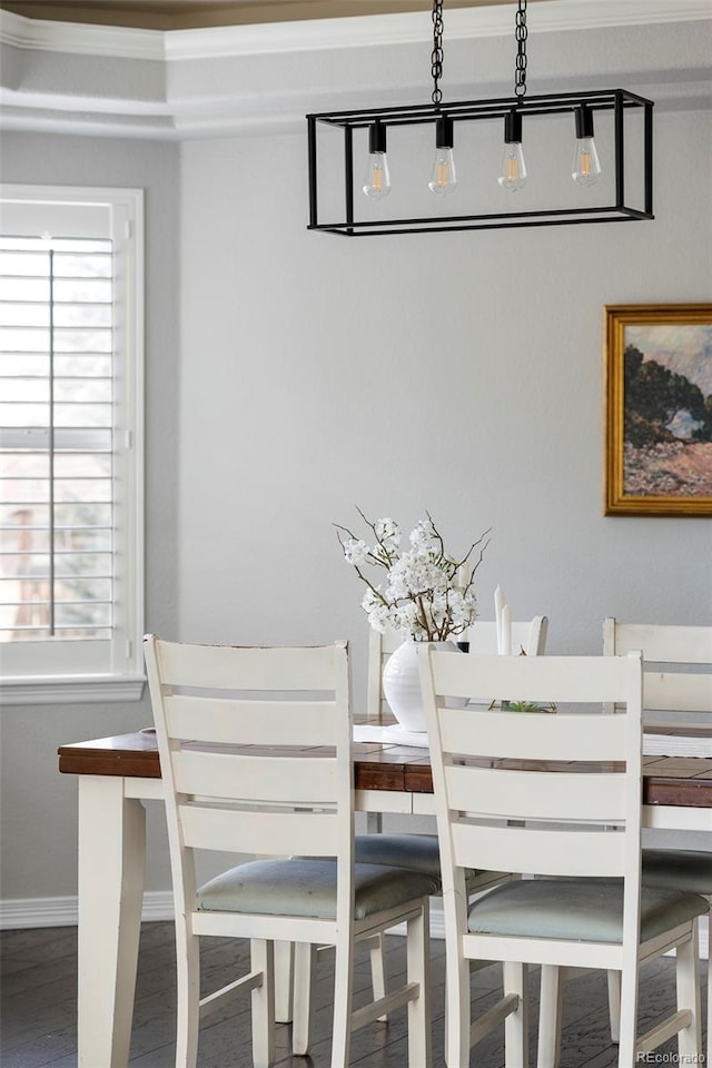 dining area with baseboards, a healthy amount of sunlight, and wood finished floors