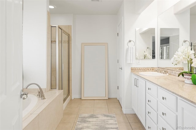 full bathroom featuring tile patterned floors, a stall shower, vanity, and a bath