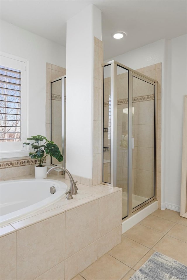 full bath with tile patterned floors, a garden tub, and a stall shower