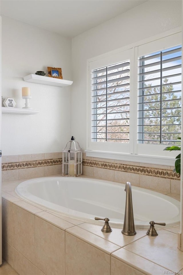 full bathroom featuring a bath and plenty of natural light