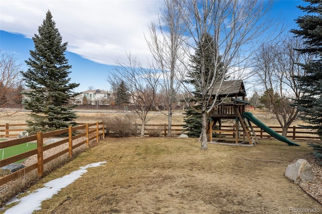 view of yard featuring a playground and fence