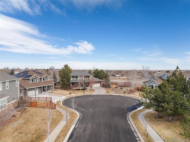 view of street featuring a residential view, curbs, and sidewalks