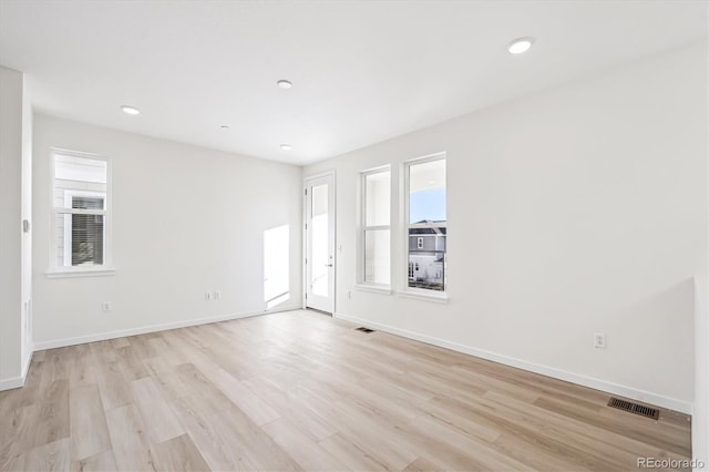 empty room with light hardwood / wood-style floors