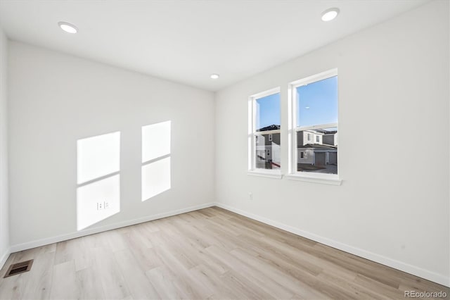 spare room with light hardwood / wood-style floors