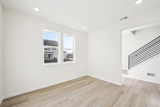 unfurnished room with light hardwood / wood-style flooring