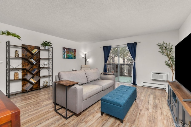 living room with an AC wall unit, a textured ceiling, baseboard heating, and light wood-style flooring