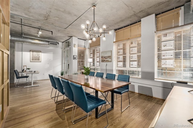 dining space featuring a chandelier and light wood-type flooring