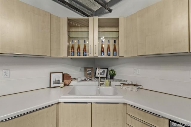 kitchen featuring light brown cabinetry and sink