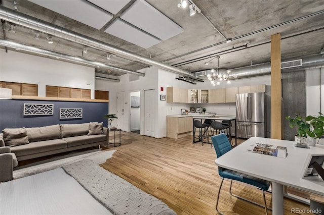 living room featuring light hardwood / wood-style floors and a high ceiling