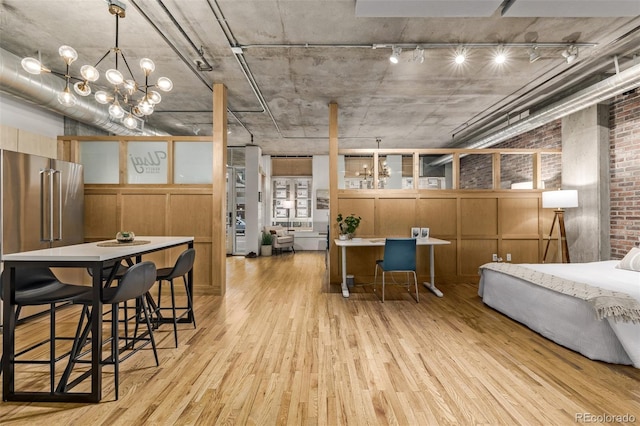 interior space with an inviting chandelier and light wood-type flooring