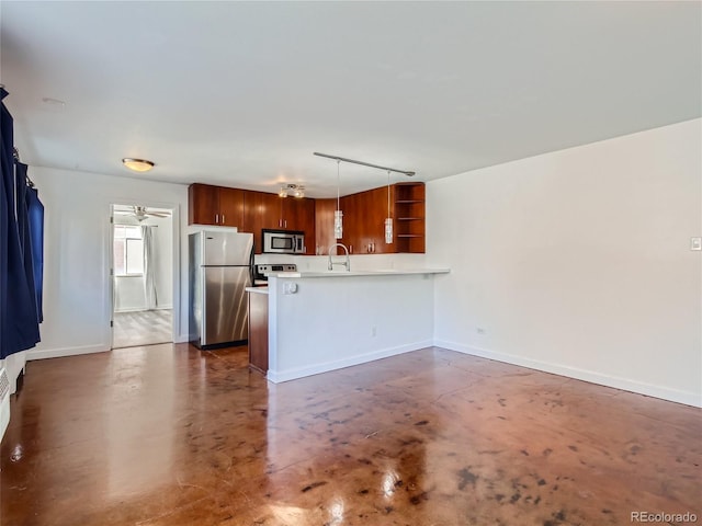 500 E 11th Ave Unit 203, Denver, CO 80203 - kitchen featuring stainless steel appliances, a peninsula, finished concrete flooring, light countertops, and open shelves