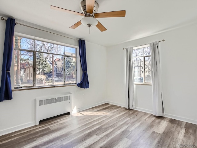 500 E 11th Ave Unit 203, Denver, CO 80203 - empty room featuring radiator, wood finished floors, and a ceiling fan