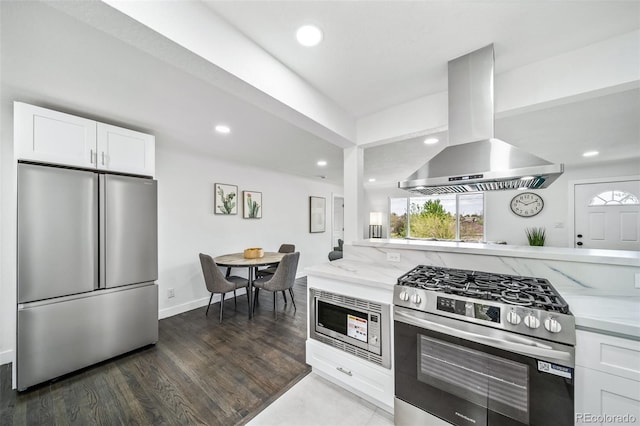 4640 W Ellsworth Ave, Denver, CO 80219 - kitchen featuring appliances with stainless steel finishes, island exhaust hood, light stone countertops, white cabinets, and recessed lighting