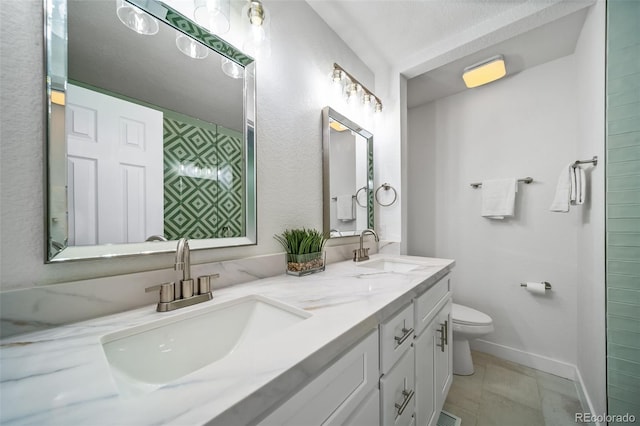 4640 W Ellsworth Ave, Denver, CO 80219 - full bathroom featuring toilet, baseboards, and double vanity