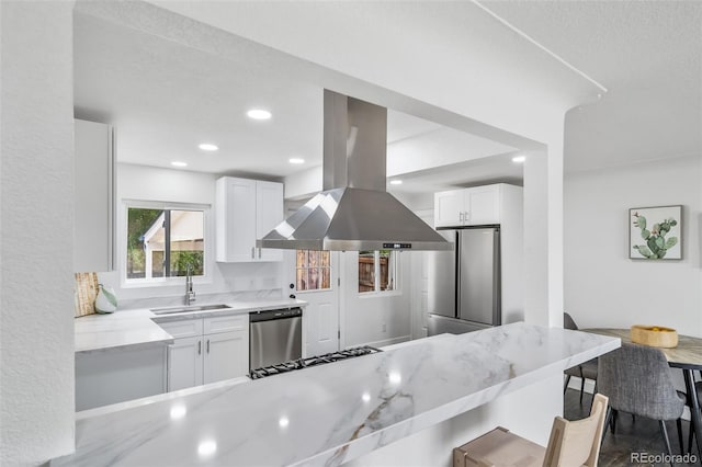 4640 W Ellsworth Ave, Denver, CO 80219 - kitchen featuring a sink, appliances with stainless steel finishes, island range hood, white cabinets, and light stone countertops