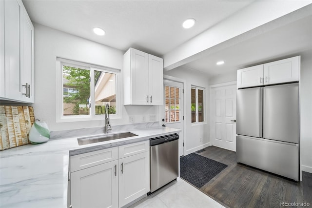 4640 W Ellsworth Ave, Denver, CO 80219 - kitchen featuring stainless steel appliances, a sink, white cabinetry, light stone counters, and recessed lighting