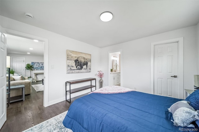 4640 W Ellsworth Ave, Denver, CO 80219 - bedroom featuring dark wood finished floors, baseboards, and ensuite bath