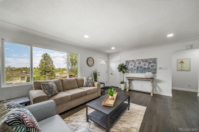 4640 W Ellsworth Ave, Denver, CO 80219 - living area featuring recessed lighting, dark wood-style floors, a textured ceiling, baseboards, and arched walkways