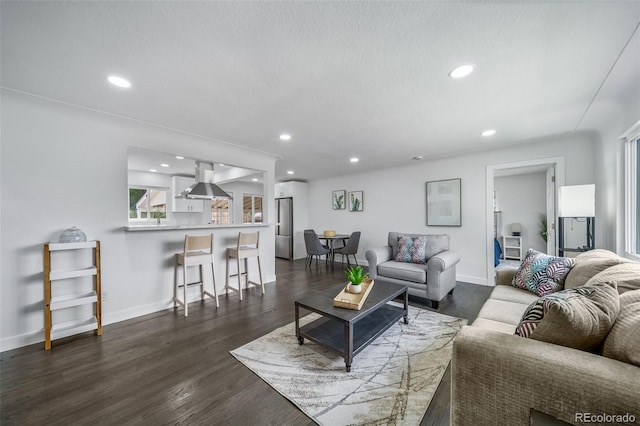 4640 W Ellsworth Ave, Denver, CO 80219 - living room featuring recessed lighting, baseboards, dark wood-style floors, plenty of natural light, and a textured ceiling