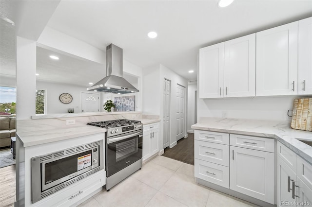 4640 W Ellsworth Ave, Denver, CO 80219 - kitchen with extractor fan, appliances with stainless steel finishes, recessed lighting, white cabinets, and light stone countertops