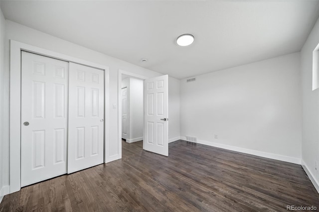4640 W Ellsworth Ave, Denver, CO 80219 - unfurnished bedroom featuring dark wood-style flooring, baseboards, and a closet