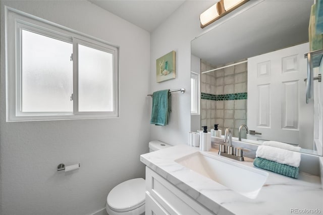 4640 W Ellsworth Ave, Denver, CO 80219 - bathroom featuring toilet, vanity, and a shower with shower curtain