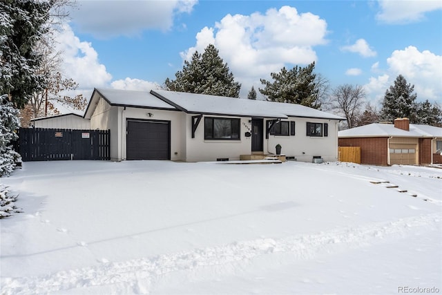 view of front of home featuring a garage, crawl space, and fence