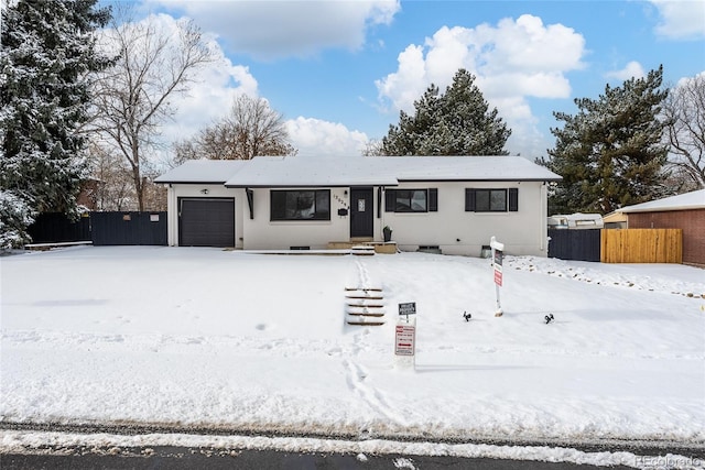 ranch-style home featuring crawl space, fence, and an attached garage