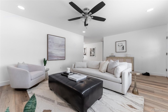 living room featuring light wood-type flooring and ceiling fan