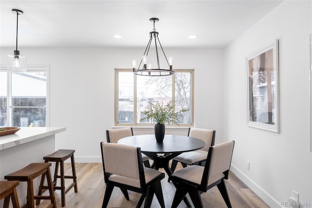 dining area featuring a notable chandelier and light hardwood / wood-style flooring