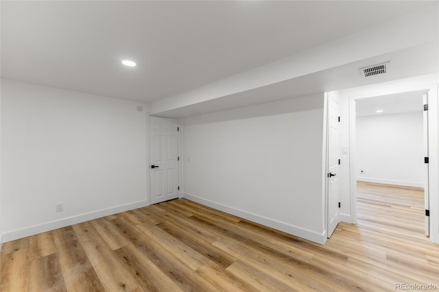 empty room with light hardwood / wood-style flooring