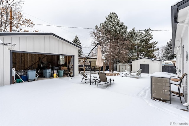 yard layered in snow with a storage unit