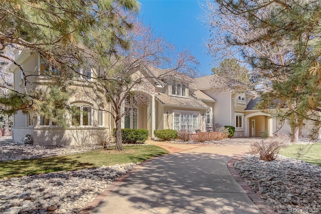 7 Mockingbird Ln, Cherry Hills Village, CO 80113 - view of front facade with stucco siding and driveway