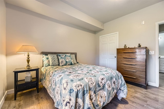 12818 Ironstone Way Unit 101, Parker, CO 80134 - bedroom featuring baseboards and wood finished floors